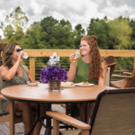 two women enjoying a meal and talking on the intracoastal deck at Best Western Plus Myrtle Beach@Intracoasta