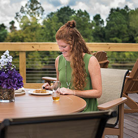 woman eating breakfast at a table on the sundeck at the Best Western Plus Myrtle Beach@Intracoastal